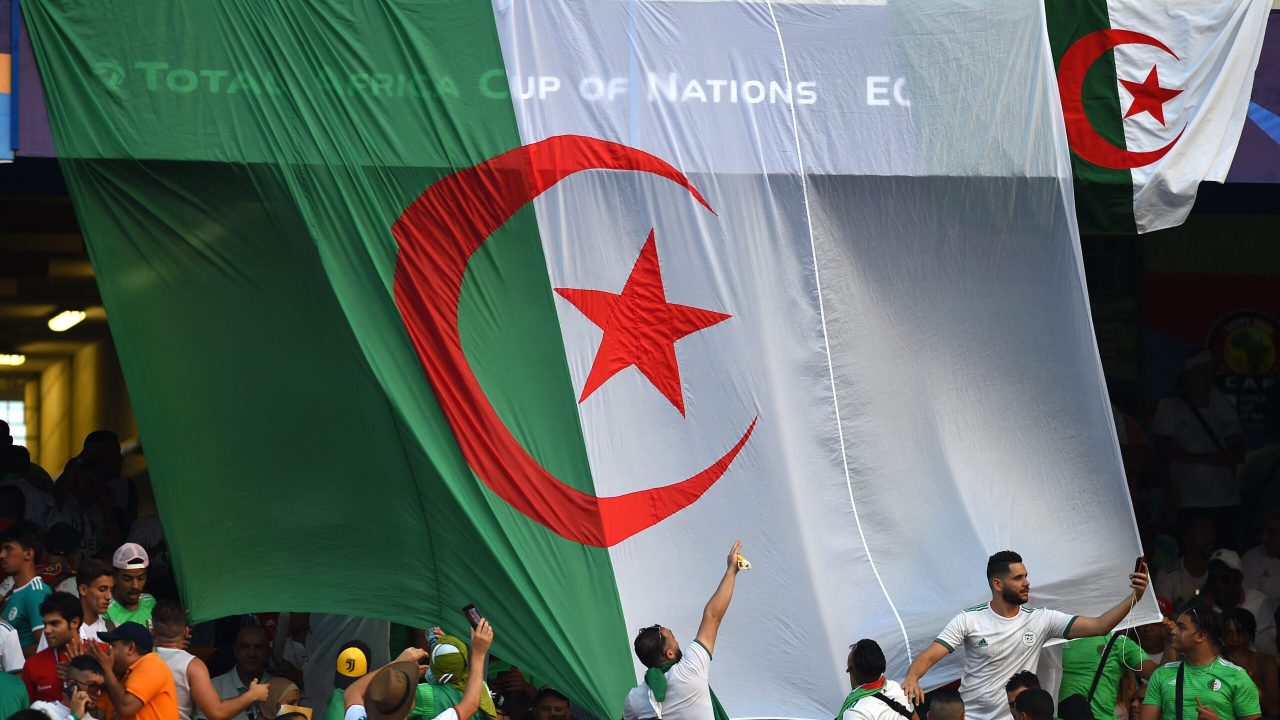 Algeria supporters wave the national flag ahead of the 2019 Africa Cup of Nations (CAN) Final football match between Senegal and Algeria at the Cairo International Stadium in Cairo on July 19, 2019. (Photo by Mohamed el-Shahed / AFP) (Photo by MOHAMED EL-SHAHED/AFP via Getty Images)