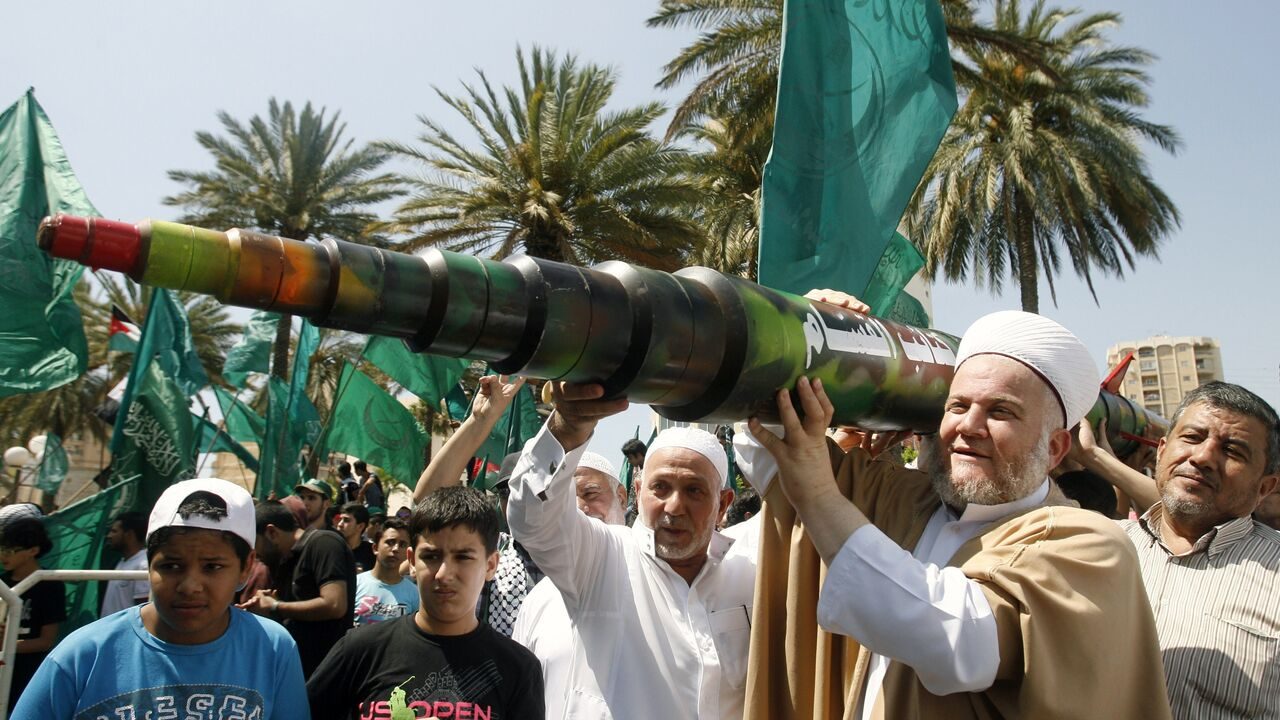 A man holds a mock Qassam rocket during a rally organised by Lebanese and Palestinian supporters of the Islamist movement Hamas and the Islamic Group, Jamaa Islamiya in solidarity with Palestinians in the Gaza strip where Hamas is engaged in a major confrontation with the Israeli army on July 11, 2014 in the southern Lebanese city of Sidon. Two Palestinians were killed in an Israeli strike, raising the toll in four days of violence to 100, Gaza health ministry spokesman Ashraf al-Qudra said. AFP PHOTO / MAHMOUD ZAYYAT        (Photo credit should read MAHMOUD ZAYYAT/AFP via Getty Images)