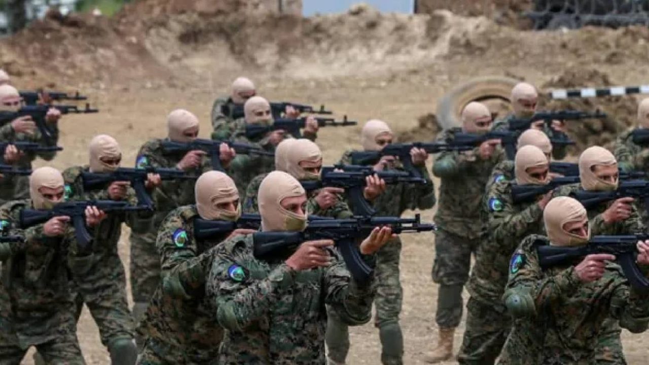 Hezb fighters pointing guns
