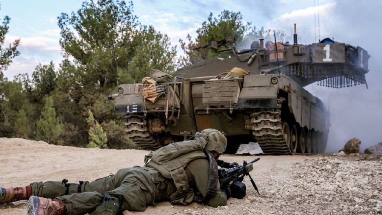 Israeli soldier next to tank