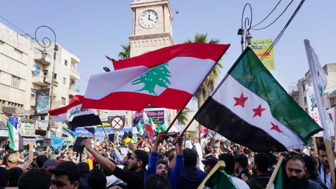 Syrians demonstrate on October 25, 2019 in the rebel-held city of Idlib in northwestern Syria in support of Lebanon's massive protests the past week, demanding better living conditions and the ouster of a cast of politicians who have monopolised power and influence there for decades. (Photo by Muhammad HAJ KADOUR / AFP)