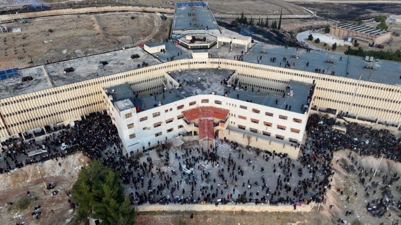 An aerial photo shows people gathering at the Saydnaya prison in Damascus on December 9, 2024. Syrian rescuers searched the Sednaya jail, synonymous with the worst atrocities of ousted president Bashar al-Assad's rule, as people in the capital on December 9 gathered to celebrate a day after Assad fled while Islamist-led rebels swept into the capital, ending five decades of brutal rule over a country ravaged by one of the deadliest wars of the century. (Photo by OMAR HAJ KADOUR / AFP)
