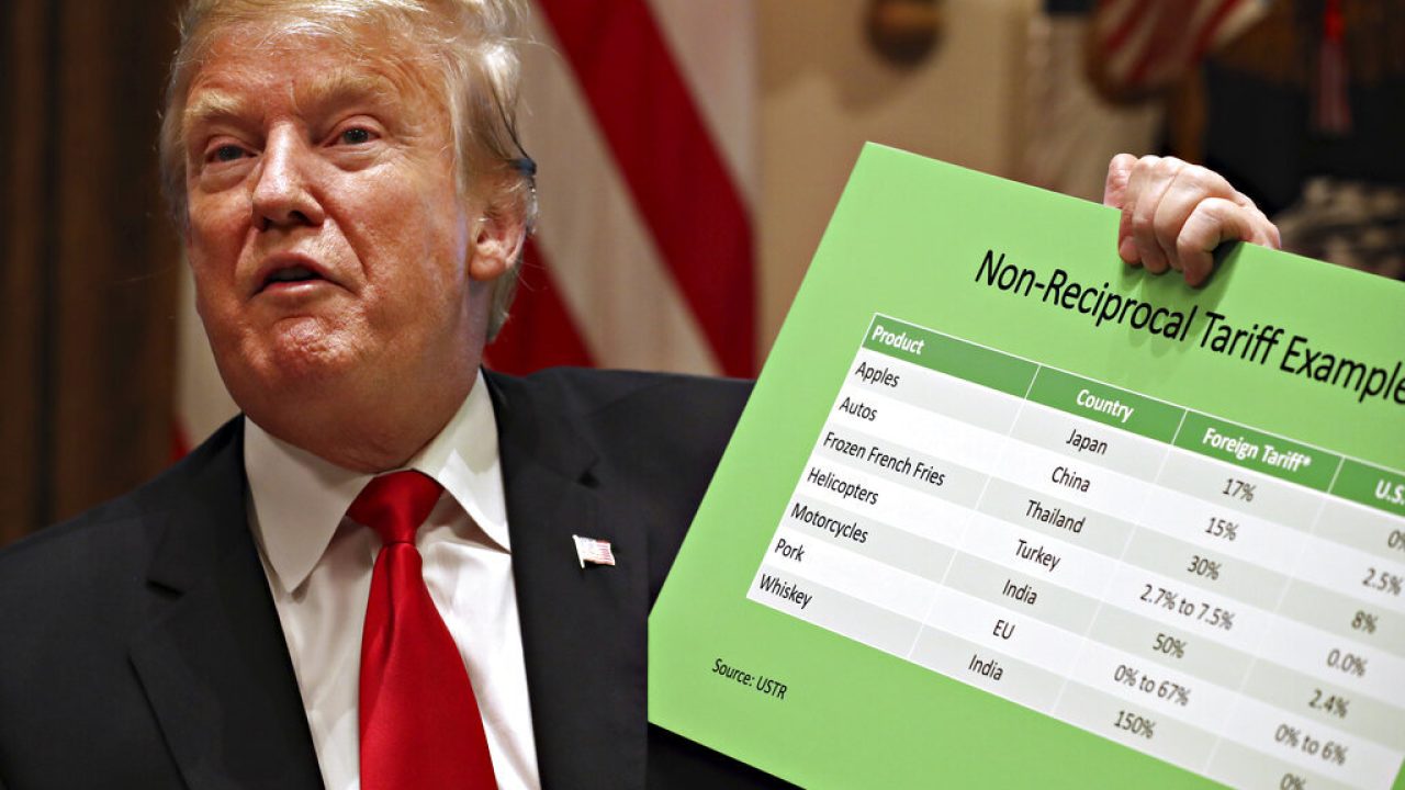 President Donald Trump holds up examples of tariffs, Thursday, Jan. 24, 2019, in the Cabinet Room of the White House in Washington. (AP Photo/Jacquelyn Martin)