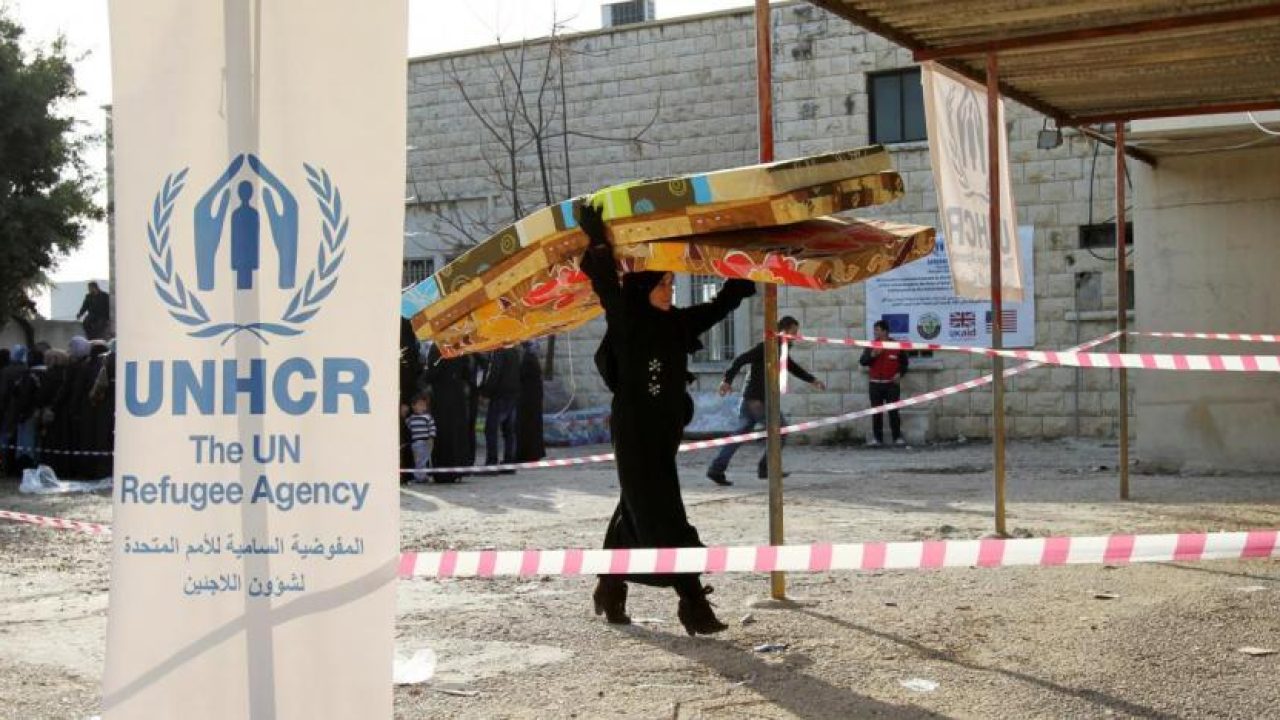 a_syrian_refugee_receives_aid_from_the_unhcr_in_batroun_northern_lebanon._reuters