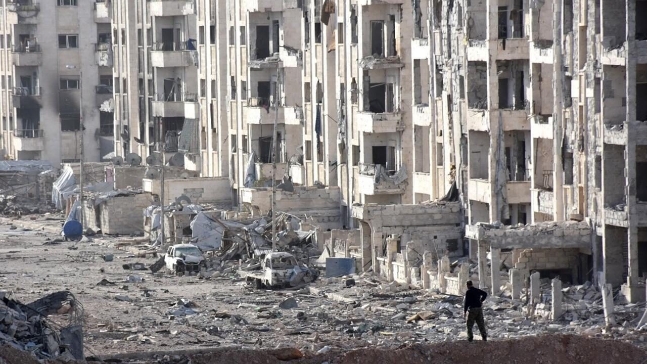A member of the Syrian pro-government forces stands amid heavily damaged buildings in Aleppo's 1070 district on November 8, 2016, after troops seized it from rebel fighters.
Syrian state media said government forces had advanced southwest of divided second city Aleppo, seizing the 1070 district from rebel forces. The Syrian Observatory for Human Rights monitor also reported the advance, saying it would allow government forces to protect areas already under their control on the southern outskirts of Aleppo.

 / AFP PHOTO / GEORGES OURFALIAN