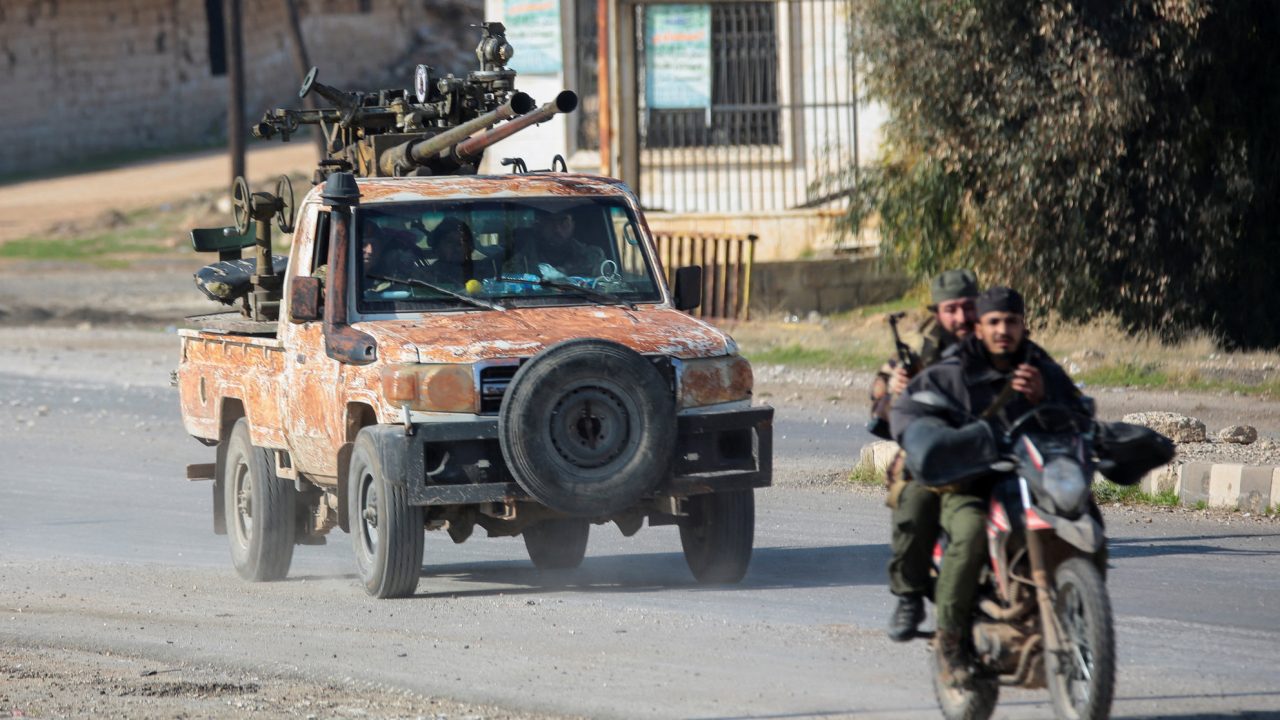 Rebels led by the Islamist militant group Hayat Tahrir al-Sham drive on a motorbike in al-Rashideen, Aleppo province, Syria November 29, 2024. REUTERS/Mahmoud Hasano