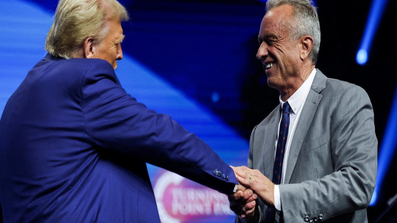 FILE PHOTO: Robert F. Kennedy Jr. and Republican presidential nominee and former U.S. President Donald Trump greet each other at a campaign event sponsored by conservative group Turning Point USA, in Duluth, Georgia, U.S., October 23, 2024. REUTERS/Carlos Barria/File Photo
