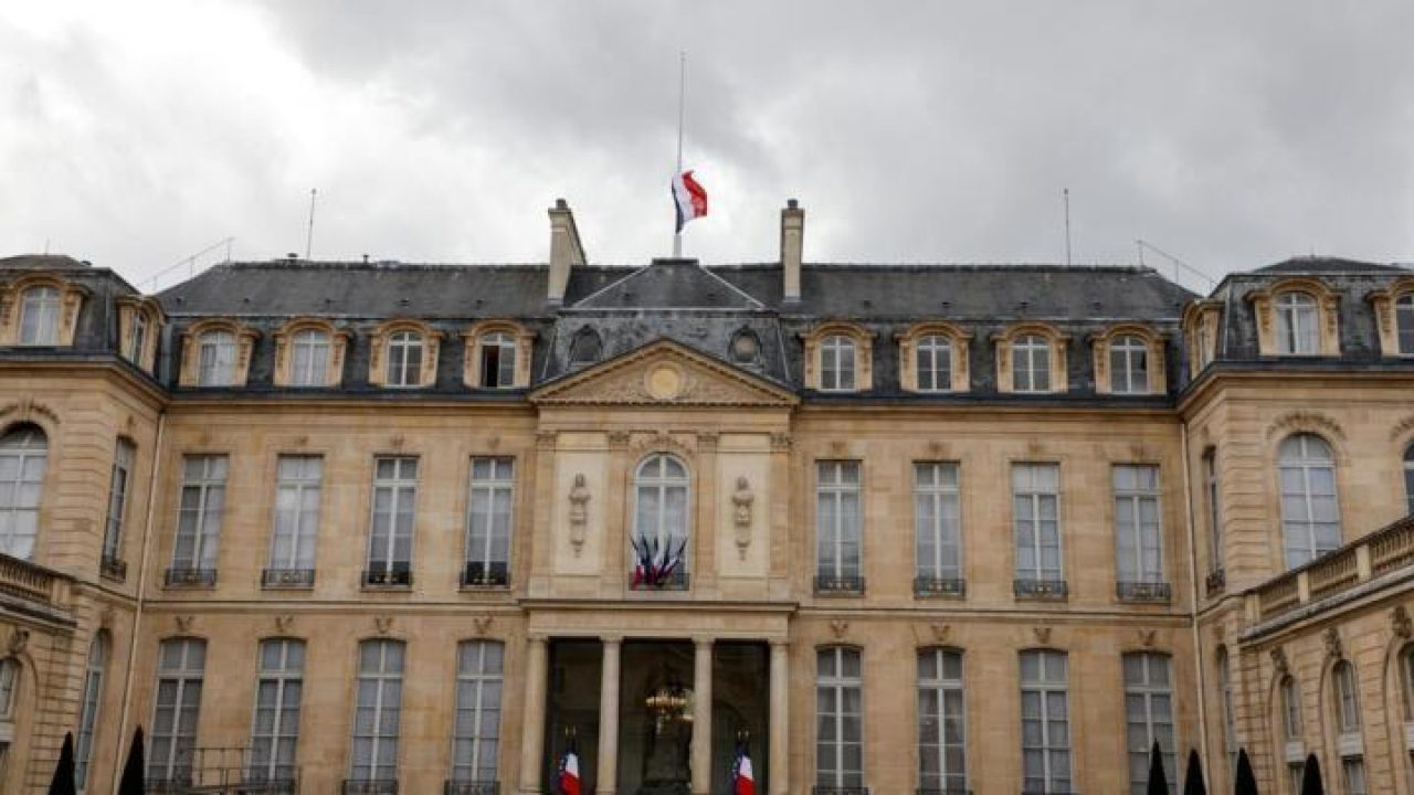 This photograph taken on October 21, 2020 shows the French flag flying at half-mast at the Elysee palace in Paris to pay tribute to slain history teacher Samuel Paty, who was beheaded by an attacker for showing pupils cartoons of the Prophet Mohammed in his civics class, on October 16, 2020, in Conflans-Sainte-Honorine, northwest of Paris. - France will pay tribute on October 21, 2020 to a history teacher beheaded for showing cartoons of the Prophet Mohamed in a free speech lesson in a gruesome attack that has shocked the country and prompted a government crackdown on radical Islam. (Photo by Ludovic MARIN / AFP)