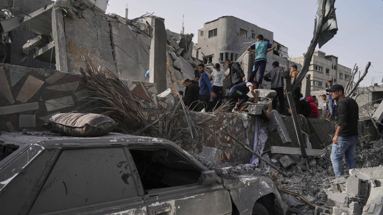 Palestinians search for survivors amid the debris of a building destroyed by an Israeli airstrike in Deir al-Balah, Gaza Strip, on Monday, April 7, 2025. (AP Photo/Abdel Kareem Hana)