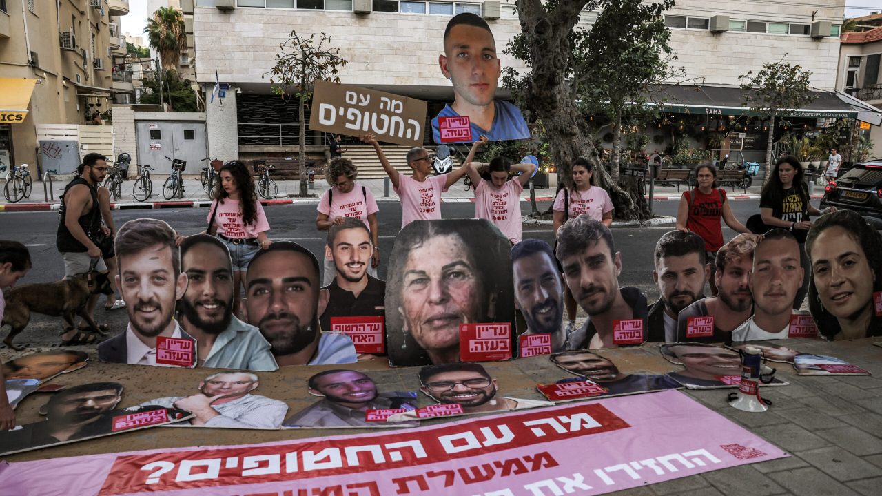 Activists gather for a demonstration calling not to forget the Israeli hostages held captive in Gaza since the 2023 October 7 attacks, amid the ongoing conflict with Iran, outside the Israeli Likud party headquarters in Tel Aviv on June 21, 2025. (Photo by AHMAD GHARABLI / AFP)