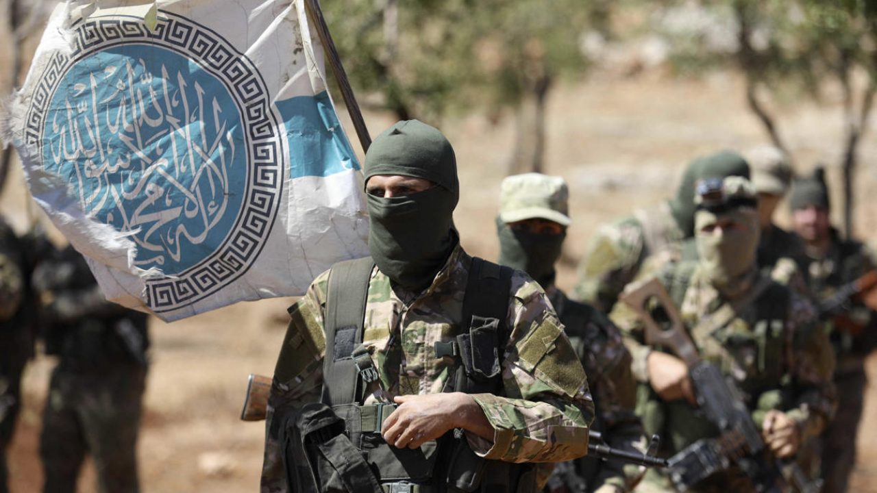 Syrian fighters attend a mock battle in anticipation of an attack by the regime on Idlib province and the surrounding countryside, during a graduation of new Hayat Tahrir al-Sham (HTS) members at a camp in the countryside of the northern Idlib province on August 14, 2018. (Photo by OMAR HAJ KADOUR / AFP)