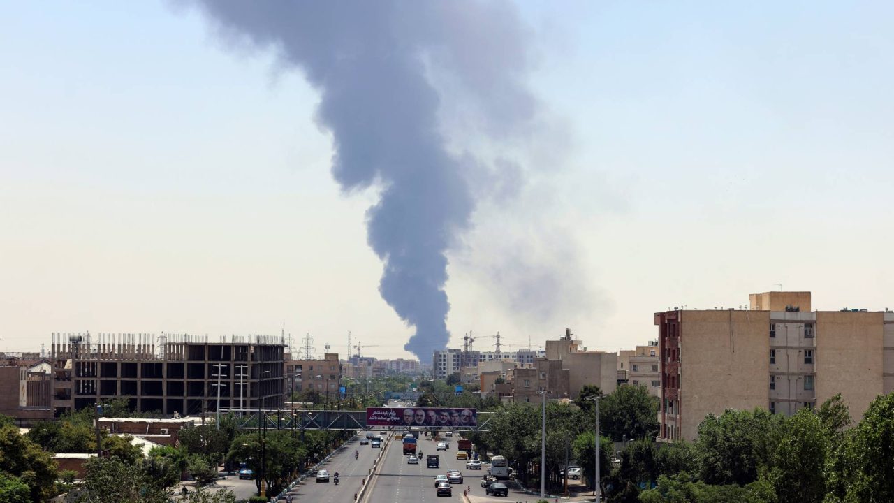 epa12176952 Smoke from an oil refinery rises over residential buildings in southern Tehran, Iran, 15 June 2025. Israel continued to target sites related to Iran's nuclear program and energy facilities, after launching strikes across Iran since 13 June. In retaliation, Iran launched waves of missiles and drones toward Israel.  EPA/ABEDIN TAHERKENAREH