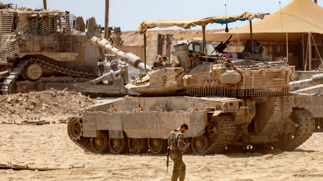 An Israeli army main battle tank is deployed at a position along the border with the Gaza Strip in southern Israel on July 23, 2025. (Photo by Jack GUEZ / AFP)