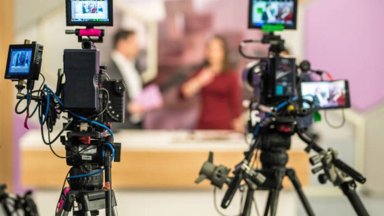Rear view of two cameras filming an infomercial TV-show. Rear view of two cameras filming an infomercial TV-show.
