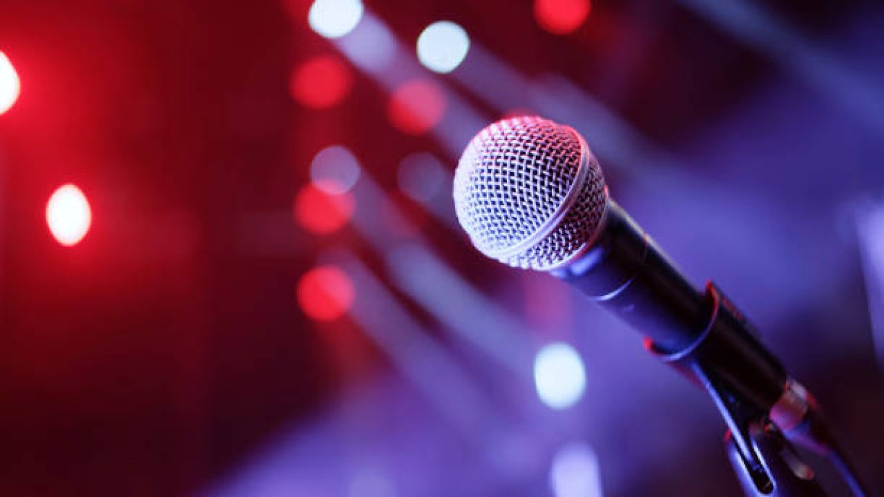 Microphone on stage with lights in background Microphone on stage with lights in background