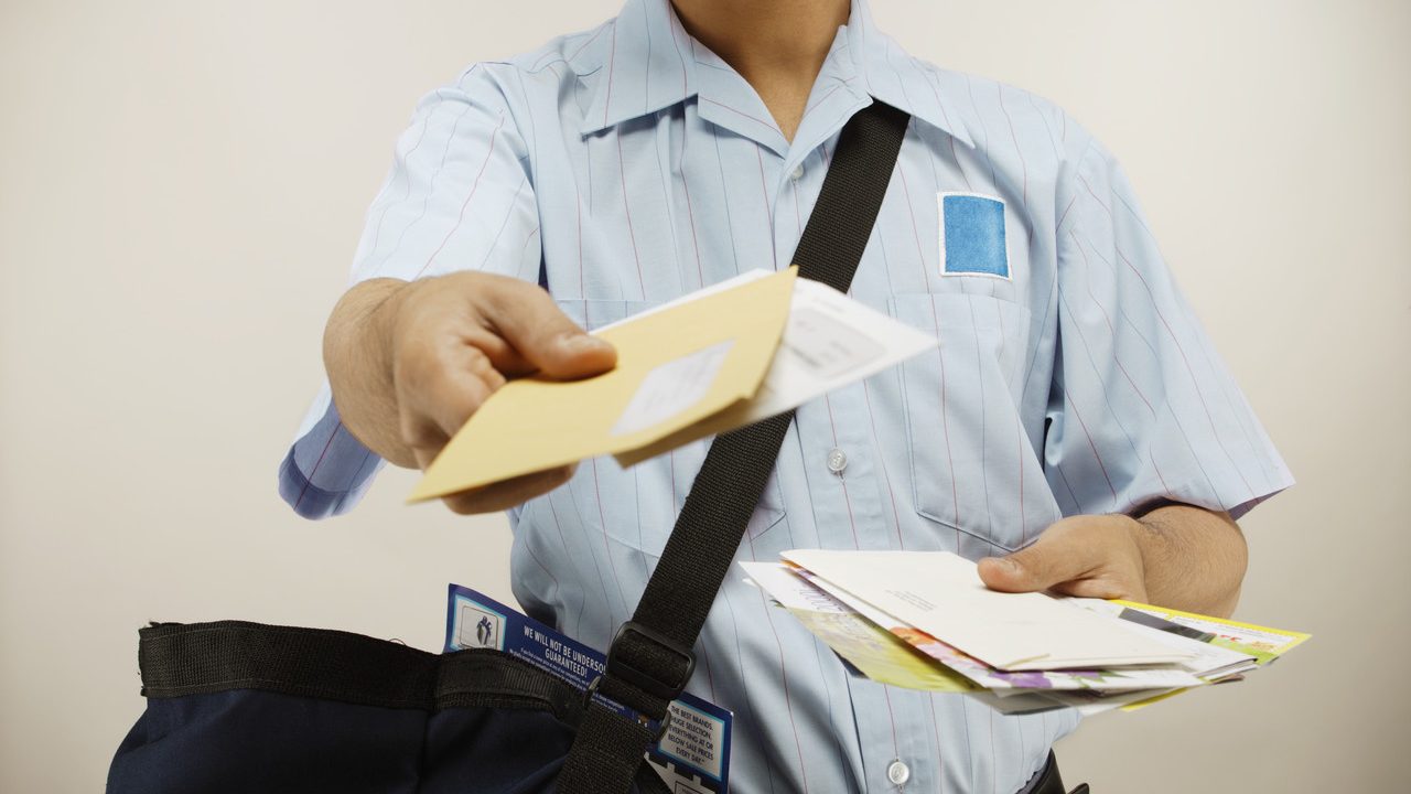 Postman delivering mail --- Image by © Royalty-Free/Corbis