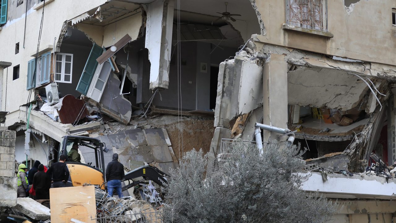 Civil defence and rescue workers remove rubbles from a building that was attacked Wednesday night by an Israeli airstrike, in Nabatiyeh town, south Lebanon, Thursday, Feb. 15, 2024. The airstrike killed and injured several people and child, Lebanon's state news agency reported. The attack is a major escalation along the already tense Lebanon-Israel border and came hours after another attack in a southern Lebanese village killed a woman and her two sons. (AP Photo/Mohammed Zaatari)