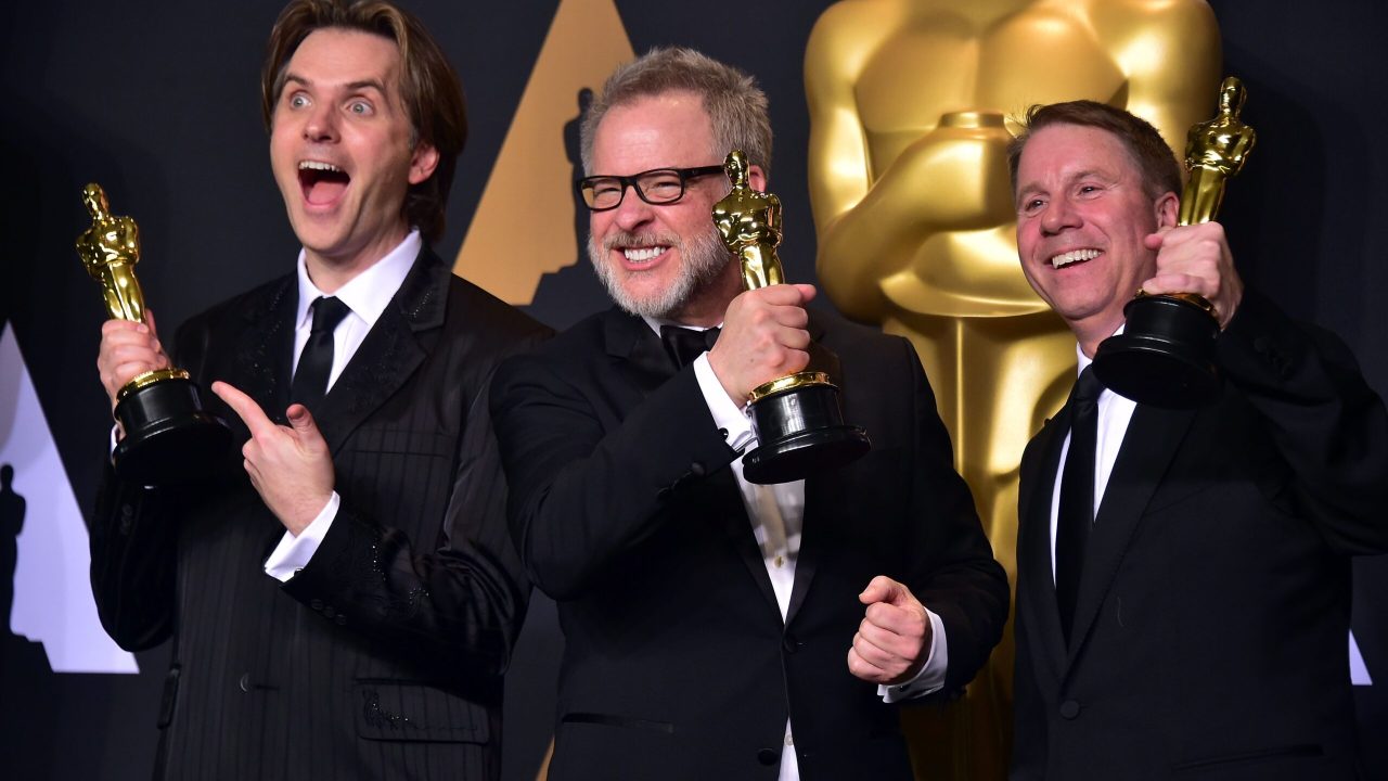 US Directors Byron Howard (L), Rich Moore (C) and producer Clark Spencer pose with the Oscar for Best Animated Feature Film during the 89th Oscars on February 26, 2017, in Hollywood, California. / AFP PHOTO / FREDERIC J. BROWN