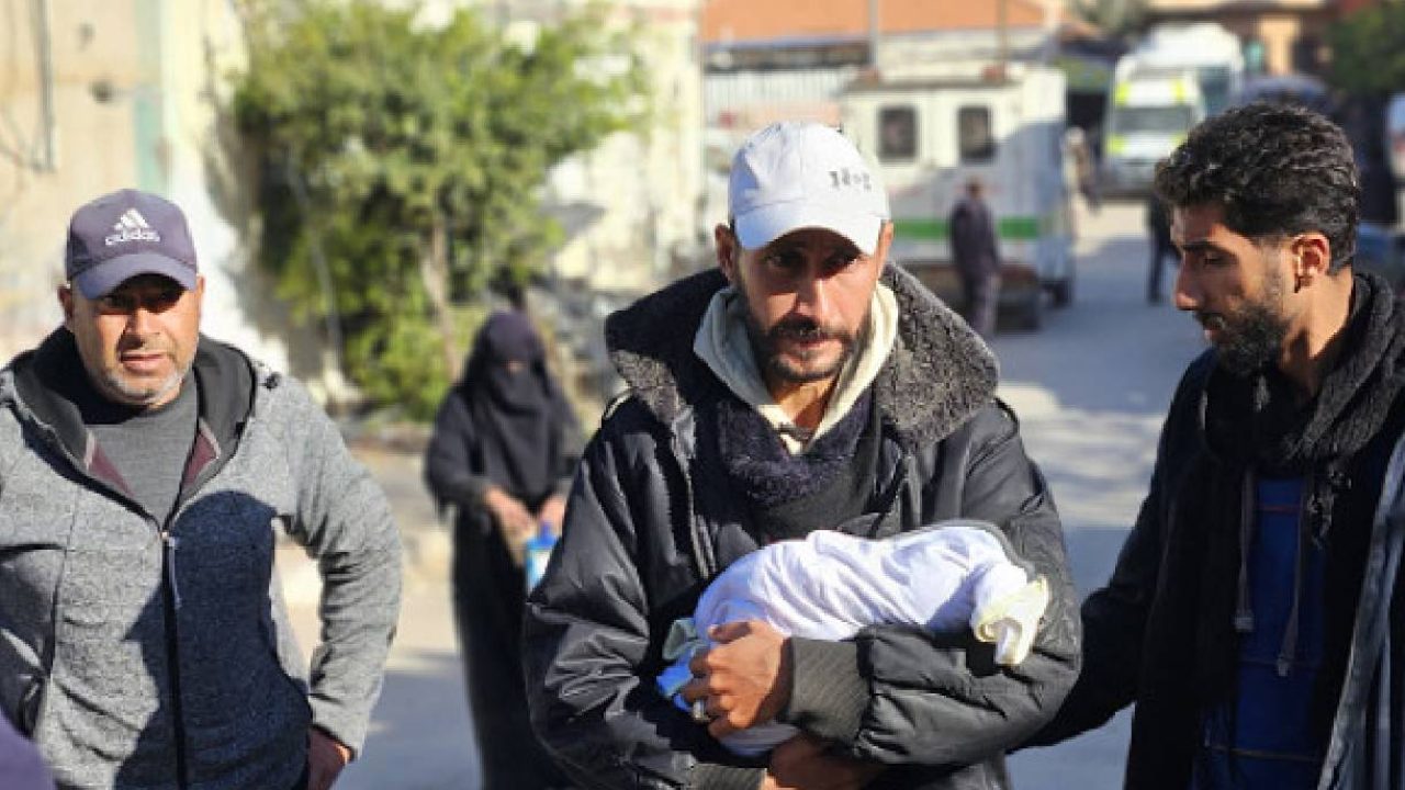 palestinian man holding baby