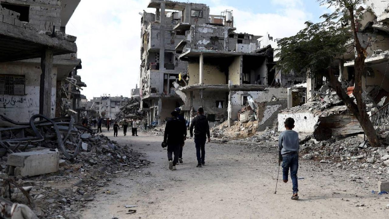 people walking in destroyed street gaza
