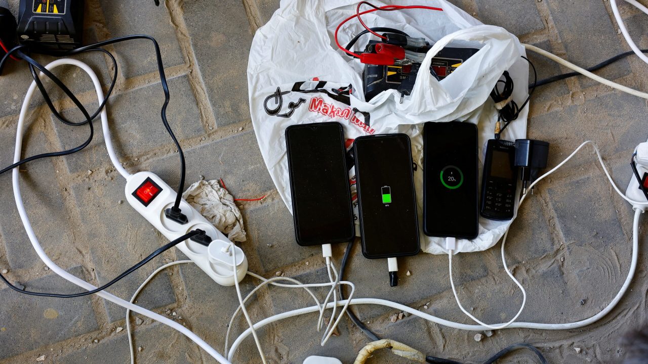 A view of mobile phones of Palestinians charged from a point powered by solar panels provided by Adel Shaheen, an owner of an electric appliances shop, as electricity remains cut during the ongoing Israeli-Palestinian conflict, in Khan Younis in the southern Gaza Strip October 19, 2023. REUTERS/Mohammed Salem