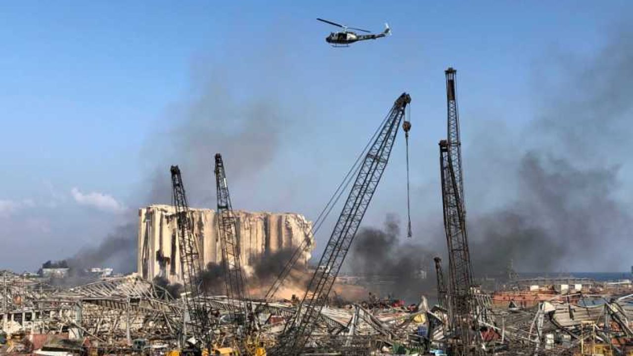 ports_1 A Lebanese army helicopter flies over the site of Tuesday's blast in Beirut's port area, Lebanon August 5, 2020. REUTERS/Issam Abdallah TPX IMAGES OF THE DAY