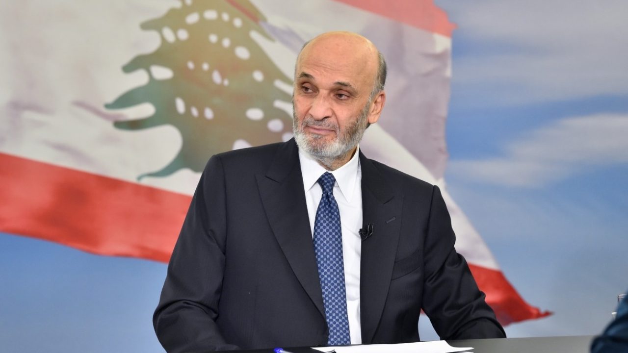 samir geagea with lebanese flag in background