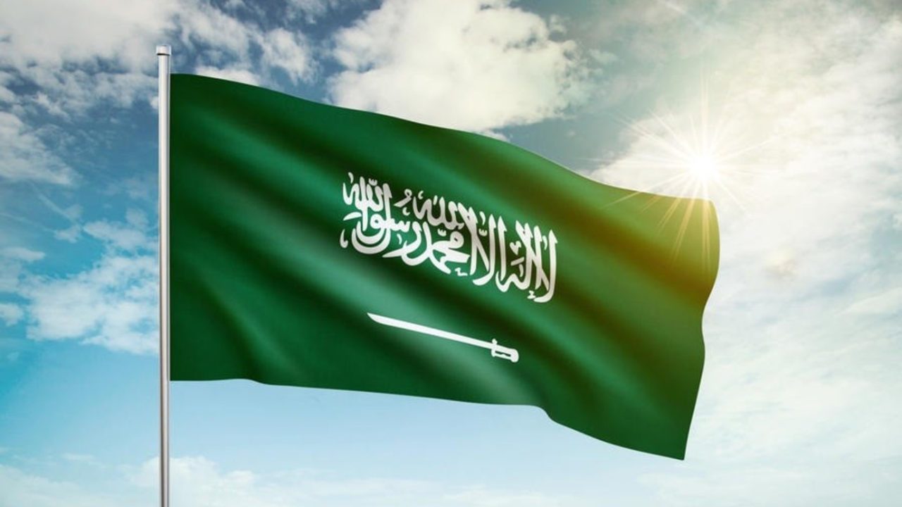 Saudi,Arabia,Flag,Waving,In,The,Wind,Against,A,Blue