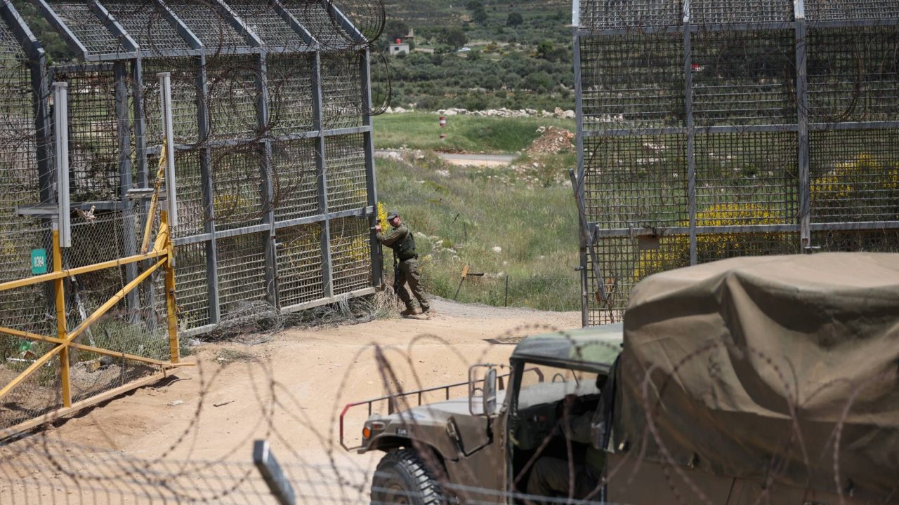 An Israeli soldier opens a gate at the border between the Israeli-occupied Golan Heights and Syria, in Majdal Shams, May 4, 2025. REUTERS/Shir Torem