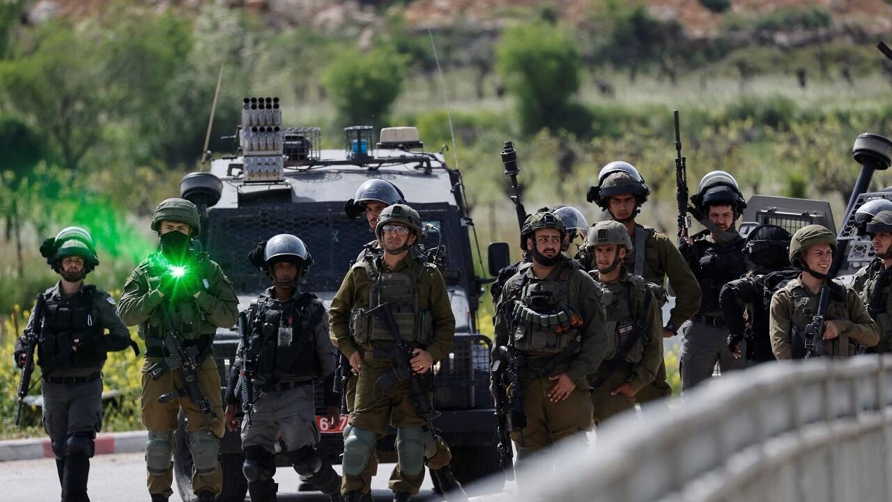 Israeli forces stand guard at a protest, following the funeral of Palestinian Mohammed Ghoneim, who medics say was killed by Israeli forces, near Bethlehem, in the Israeli-occupied West Bank April 11, 2022. REUTERS/Mussa Qawasma