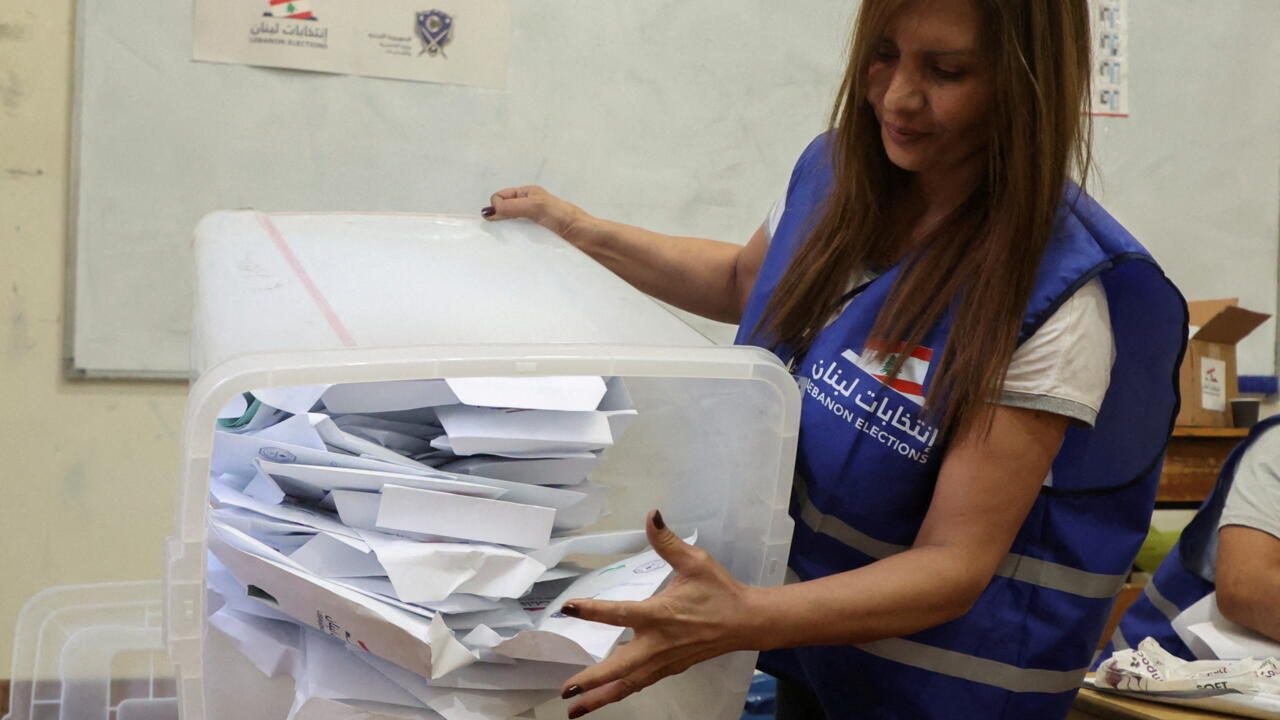 An electoral worker empties a ballot box after polls closed during Lebanon's parliamentary election in Beirut An electoral worker empties a ballot box after the polls were closed during Lebanon's parliamentary election in Beirut, Lebanon May 15, 2022. REUTERS/Mohamed Azakir
